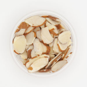 Sliced Natural Almonds With Brown Outer Shell Skin Showing In White Container On White Background