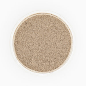 Fine Black Pepper Ground Up Close In Circular Dish On White Background