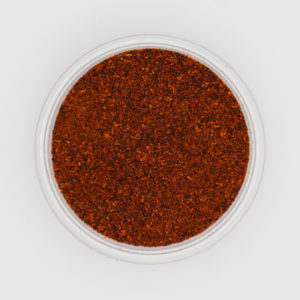 Dark Red Chili Powder Detailed Textures From Above On White Background