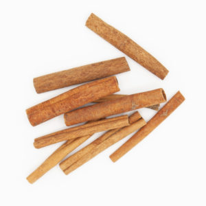 Pile Of Two And Three Quarter Cinnamon Sticks Detailed Spice Textures From Above On White Background